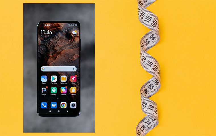 A photo of a smartphone and tape measure