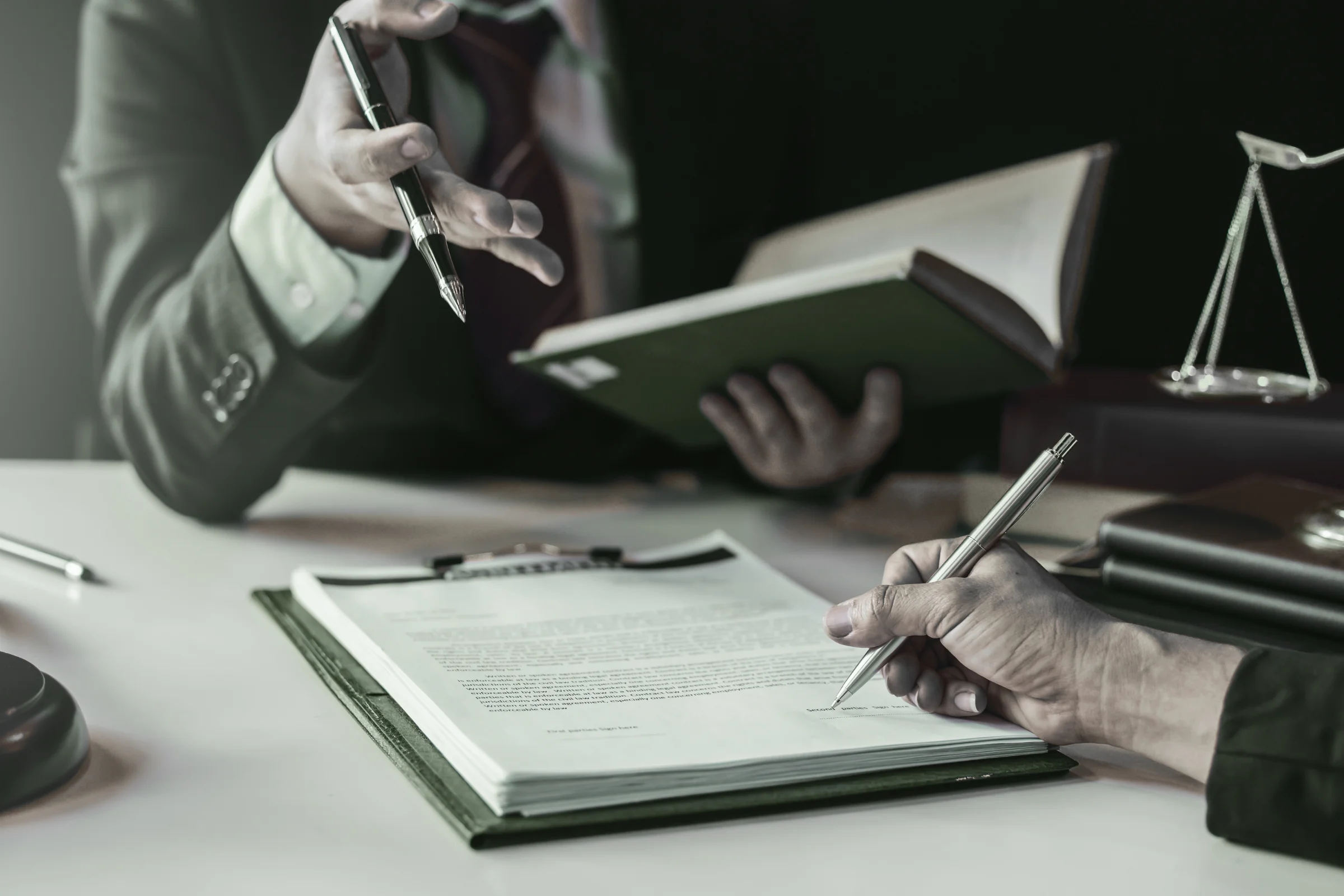 a person signing a paper